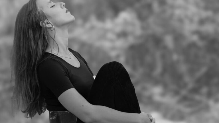 Person taking a calm breath outdoors