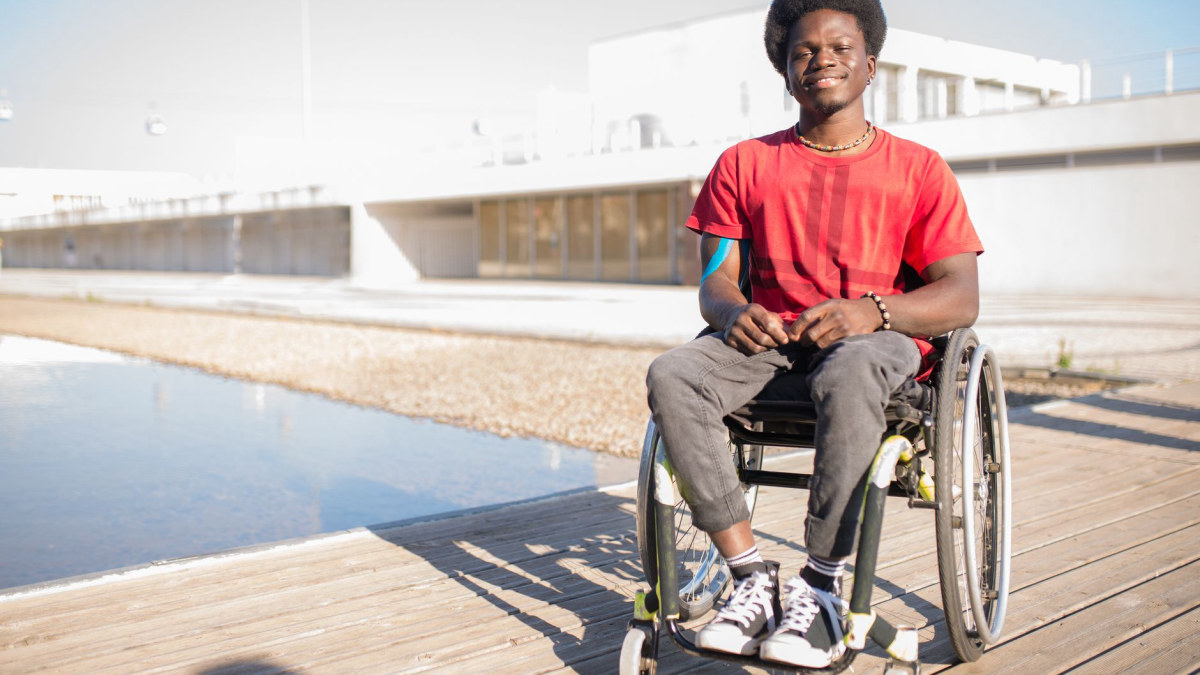 Confident person in wheelchair enjoying outdoors
