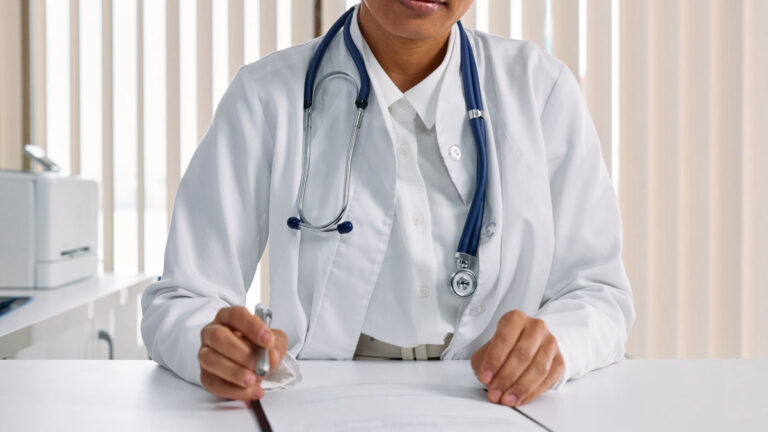 Medical professional writing clinical notes