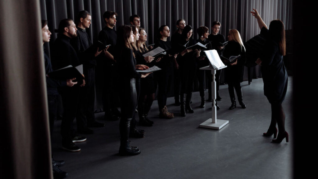 Person singing joyfully in a music setting