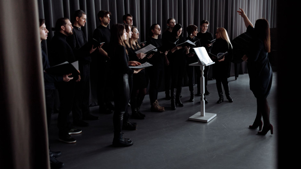 Person singing joyfully in a music setting
