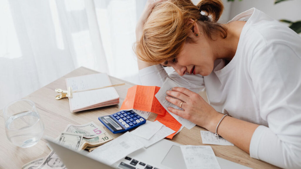 Person dealing with stressful paperwork at home