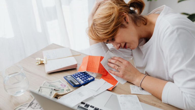 Person dealing with stressful paperwork at home